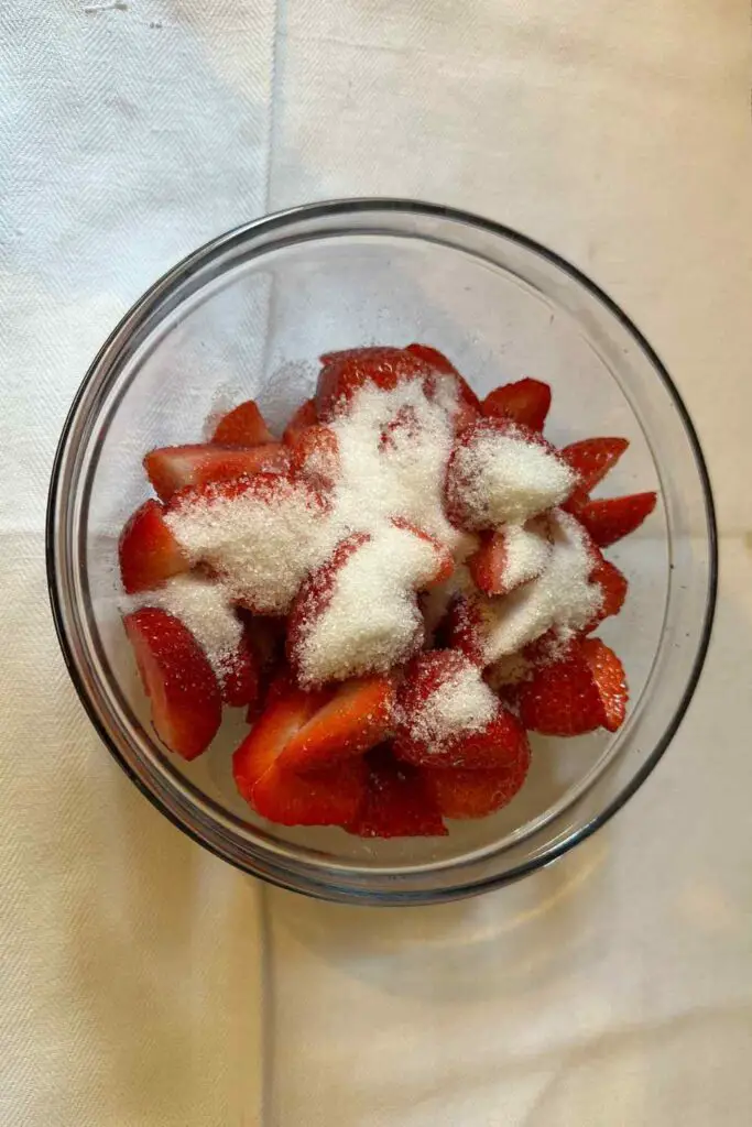 Mixing the sugar and strawberries